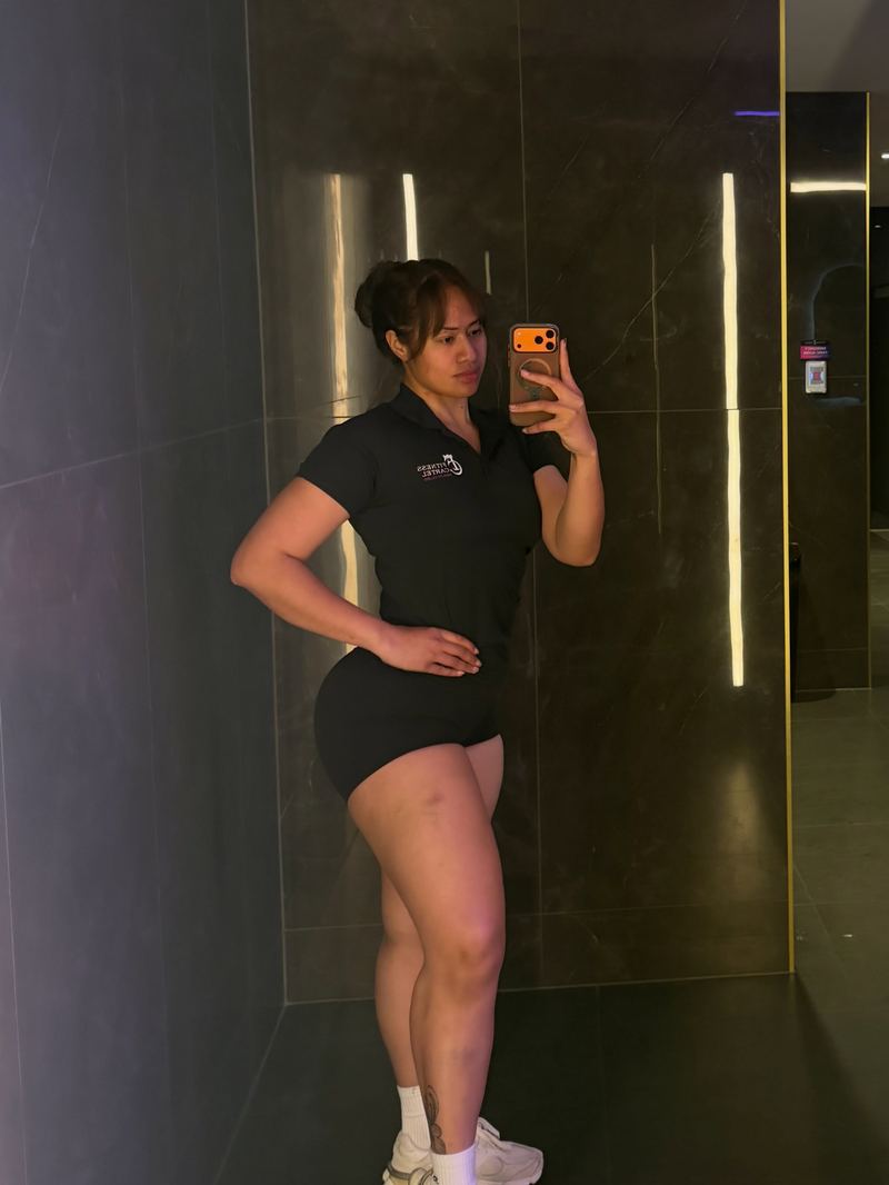 Rachel in her black Fitness Cartel trainer polo